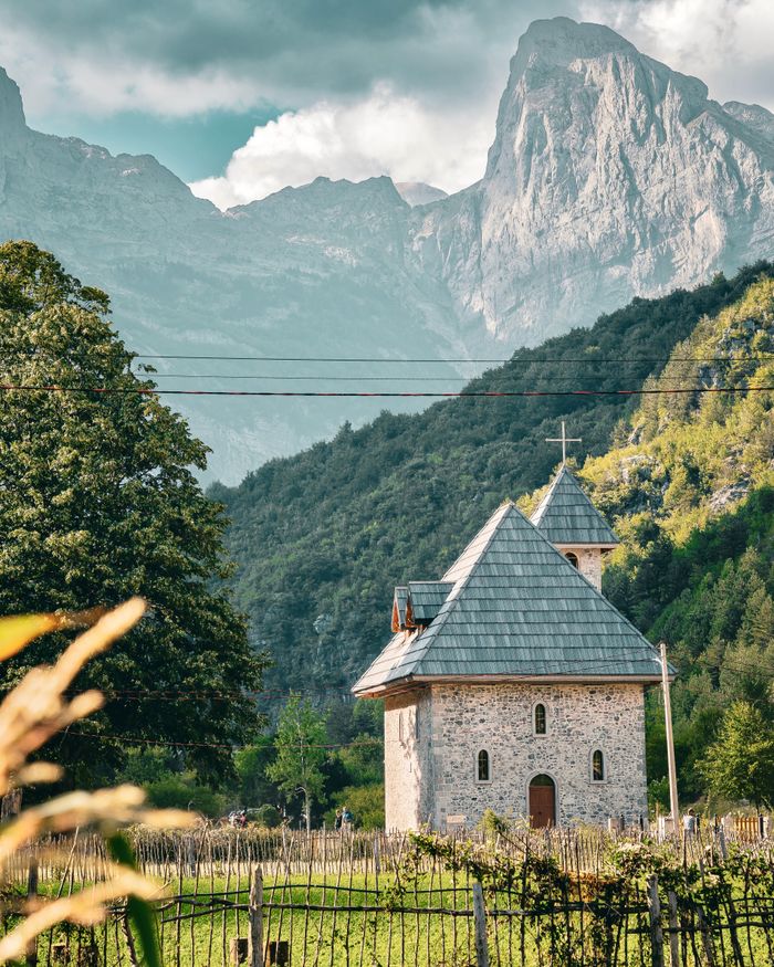 Discover a quaint chapel nestled in the picturesque Theth Valley, surrounded by majestic Albanian mountains.